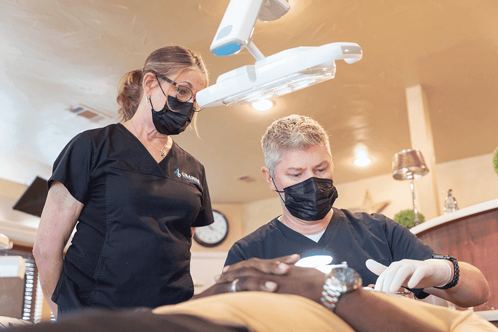 orthodontist in denton, tx working on patient with braces